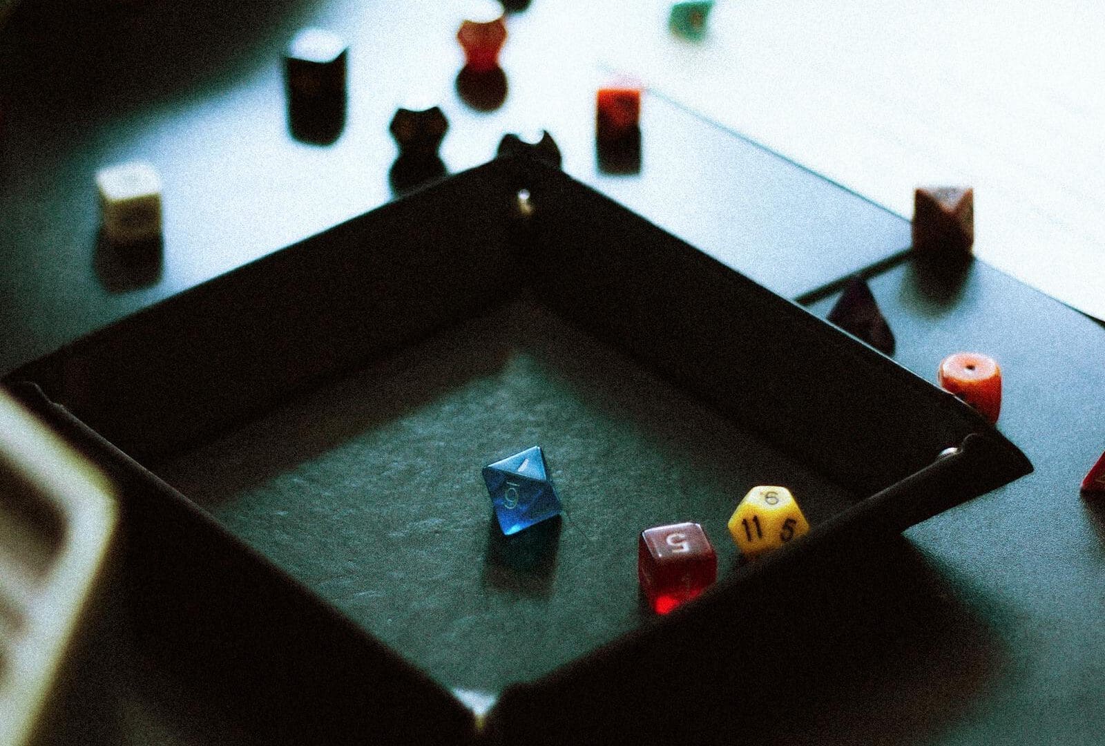 The Ultimate Guide to San Antonio Board Game Cafes & Tabletop Hubs (2026): dice tray with tabletop RPG pieces for board game cafes guide