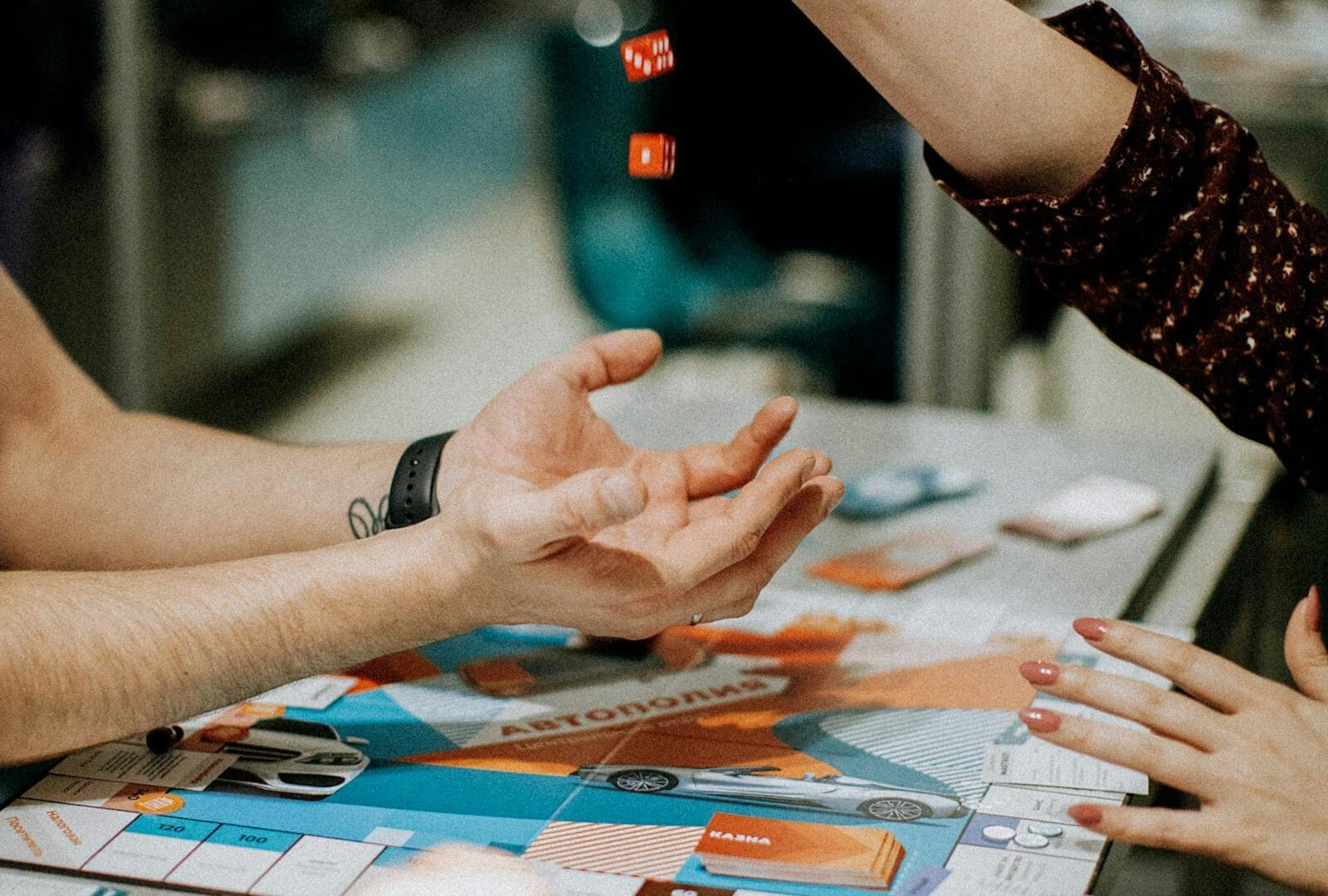 Emerald Tavern in Austin: English Pub Vibes and Heavy Board Games featured image: board game night with dice and cards for Austin tavern guide