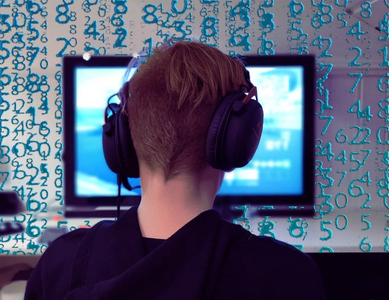 Gamer with headphones at a PC gaming setup in an esports lounge