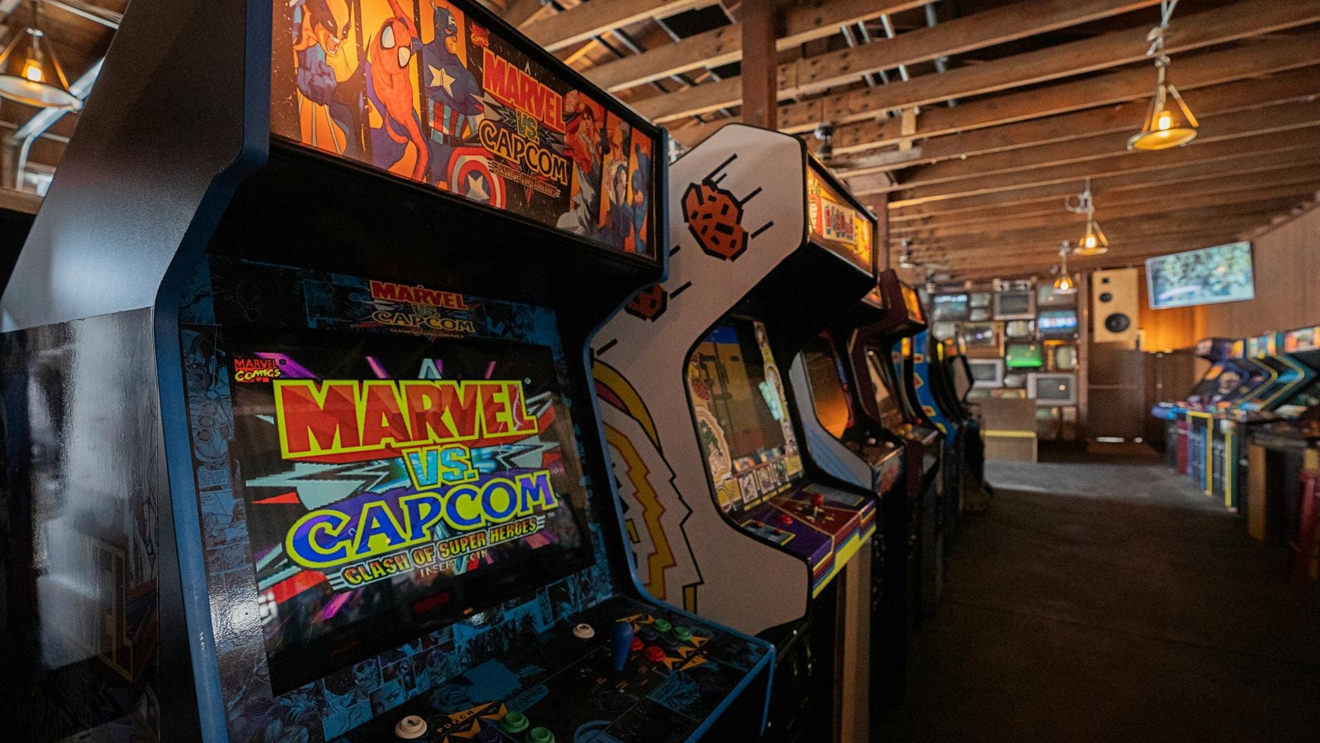 Row of pinball machines and arcade cabinets